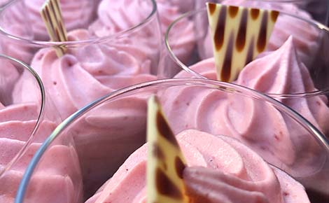 Aardbeienmousse dessert, fraai opgespoten in glazen. Mercurius Catering
